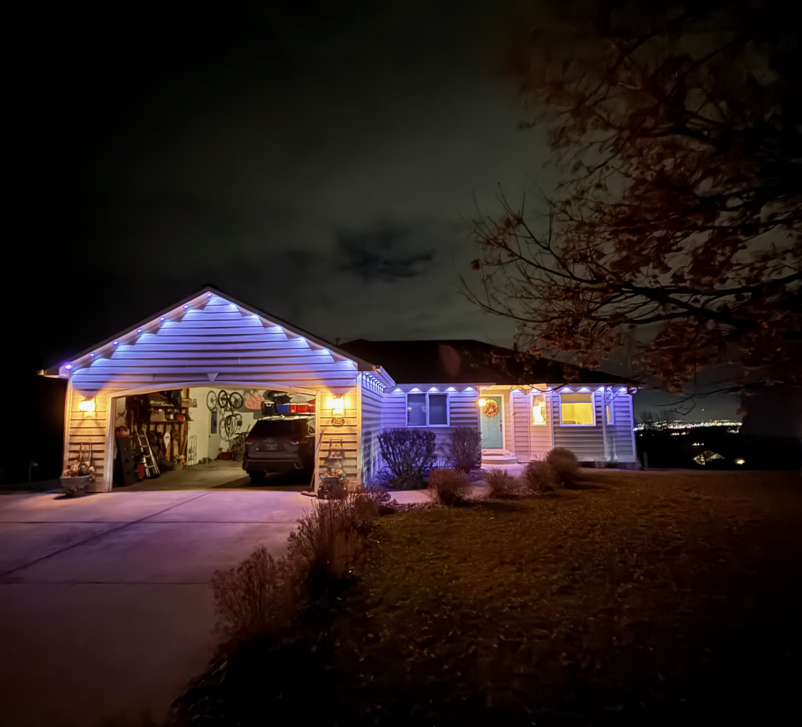 Blue roofline lighting on a single-story home by Montana Lights